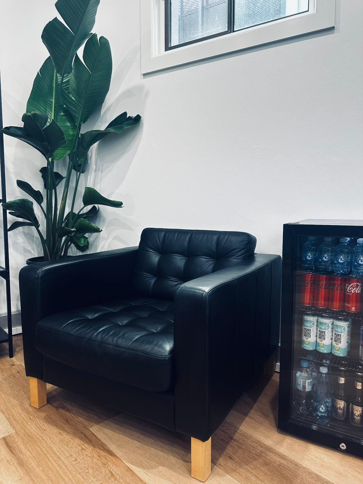 Leather chesterfield, plant, mini fridge stocked with cold drinks at Fresh By Prince