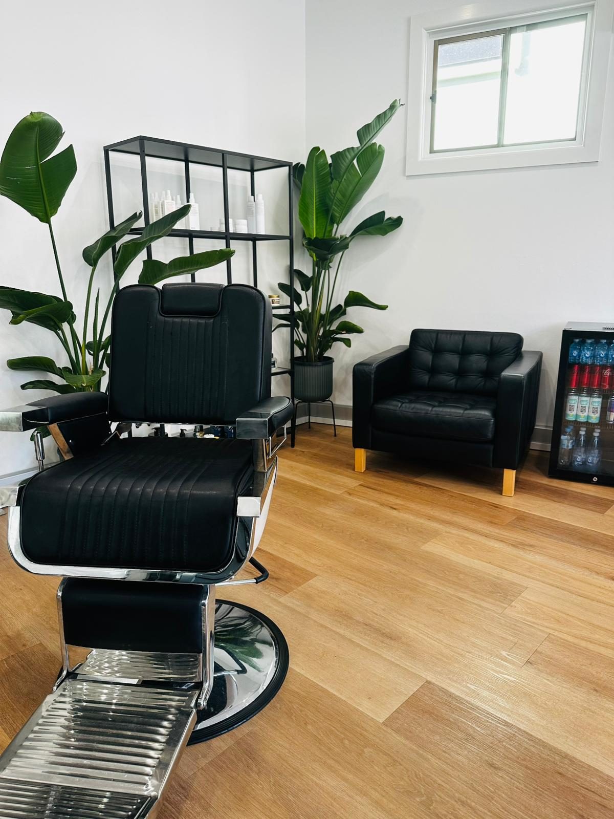 Inside Fresh By Prince — chair, bird-of-paradise plants, product shelf, leather chesterfield