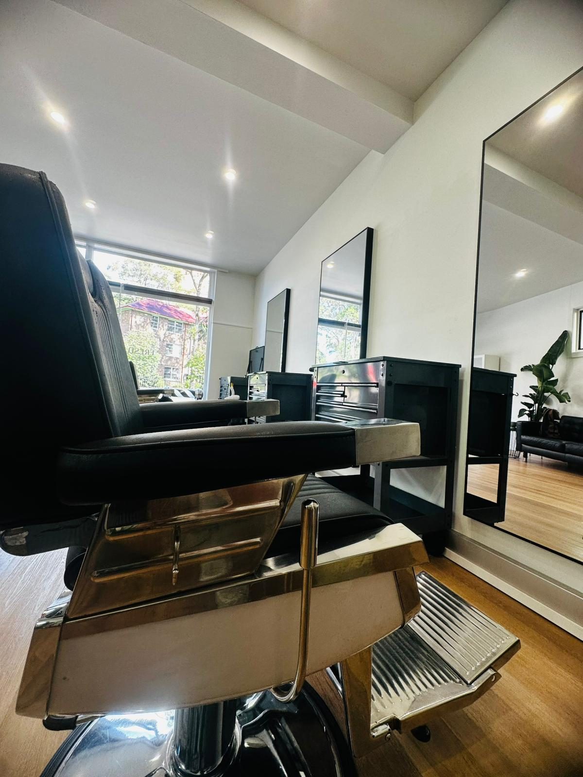 Inside Fresh By Prince — chair, mirror wall, Snap-on tool carts, plants in window light