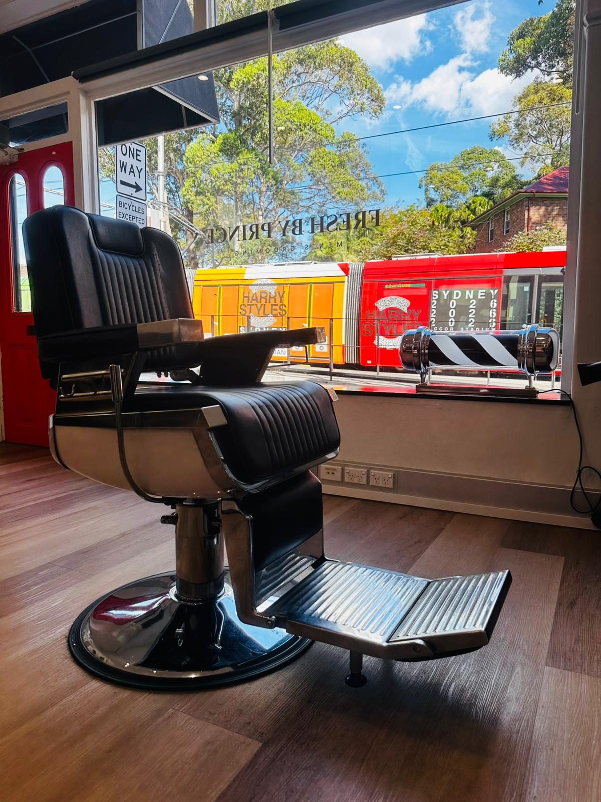 Fresh By Prince storefront window at 216 Devonshire St, Surry Hills — wordmark etched on glass with the L1 light rail passing